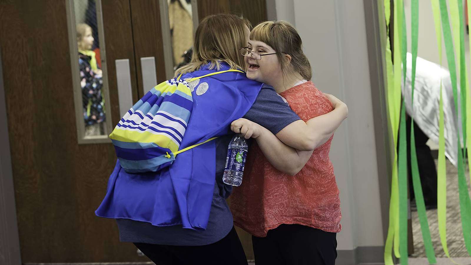 Girl receives a hug from her buddy